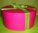 Pink round gift boxes gift wrapped in lime green corporate printed ribbon from Printed Ribbon UK (click to enlarge)